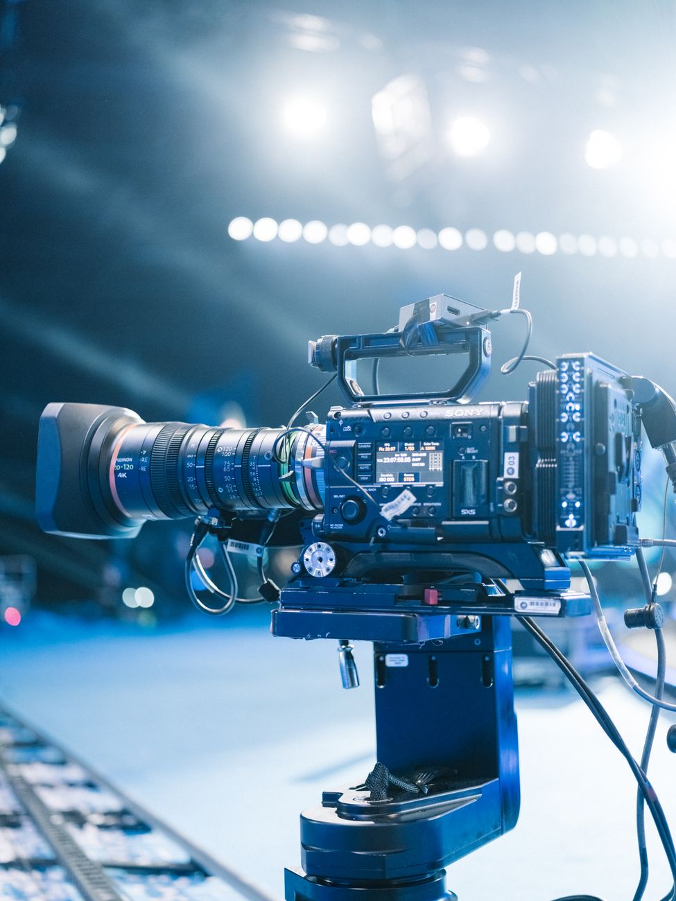 Close up on camera lens with golden reflections representing cinematic authority